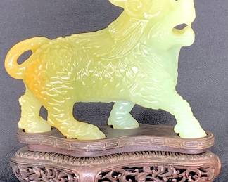 Lot 72	Chinese Carved Celadon Jade Or Serpentine Pi Xiu Mythical Beast On Carved Hardwood Stand, 20th Century