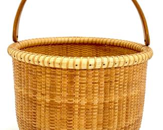 Lot 127	Ann L. Hicks (American, 20th century). Nantucket Basket with Open Swing Handle (20th century). Wood, Woven Rattan.