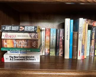 Oak Bookshelf with Assorted Books and Artwork fourth image