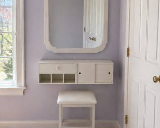 Three piece vanity station. Inches wall mirror, floating shelf with storage, and cushioned stool