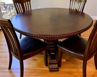 Round table, 4'10" with extensions and 8 chairs