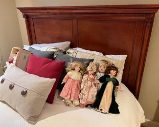 Collectible dolls by Moments Treasured, Mann, Gorham, and more; selection of throw pillows.