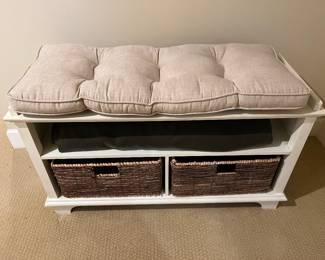 Bench with cushion and wicker basket storage.