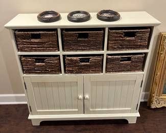 Two-drawer cabinet with wicker basket storage.