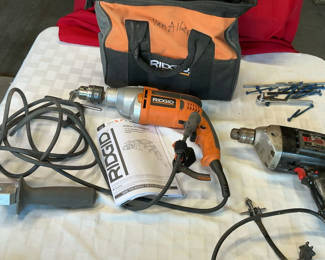Lot 60: Corded drills and accessories in tool bag