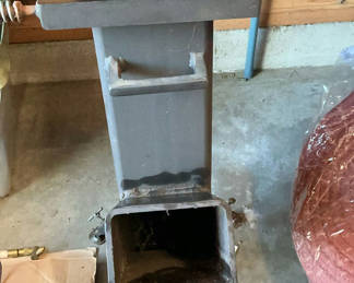 Lot 79: Metal freestanding Rocket stove with top grate and ash drawer