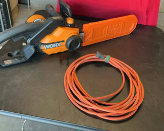 Lot 76: WORX electric chainsaw with blade cover and extension cord