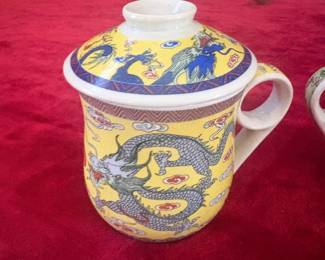 Set of 2 Two beautifully decorated lidded Chinese porcelain tea mugs. One features a yellow ground with blue and grey dragon motif; the second depicts court ladies in a garden scene with a green-topped lid. Both in good condition. A lovely pair from a diplomat's personal collection.