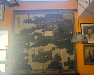 A stunning and rare 4-panel folding screen featuring a detailed painted scene of figures, boats, pagodas, and landscapes with Chinese calligraphy inscription. Dark lacquered wood frame. Diplomat provenance — brought to the U.S. from East Asia. Statement piece for any home. Approx. 6' tall x 6' wide fully open.