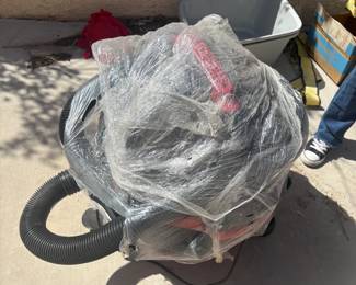  Shop-Vac — Large Capacity Large red Shop-Vac with hose and attachments included. Stored wrapped in plastic. Sold as-is — buyer to test. Great for garage, workshop, or home use.