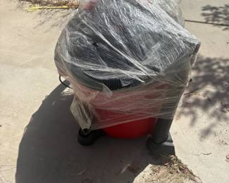  Shop-Vac — Large Capacity Large red Shop-Vac with hose and attachments included. Stored wrapped in plastic. Sold as-is — buyer to test. Great for garage, workshop, or home use.