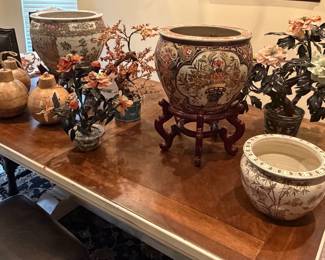 Variety of Asian fish bowls, jade trees.