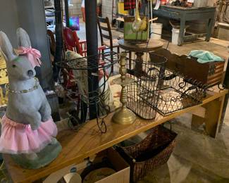 large concrete rabbit; bench; metal baskets