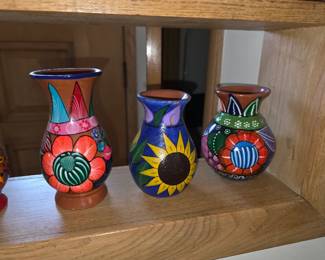 +5 These are hand-painted ceramic vases from Mexico, featuring vibrant floral designs and traditional folk art styles.