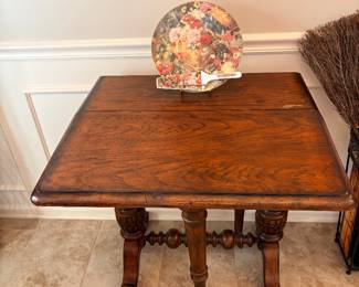 antique drop-leaf table, specifically identified as a Sutherland table or a tuck-away table
