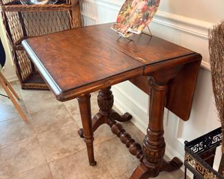antique drop-leaf table, specifically identified as a Sutherland table or a tuck-away table