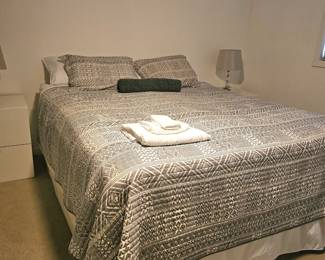 cozy bed with linen and bedspread, sold separately