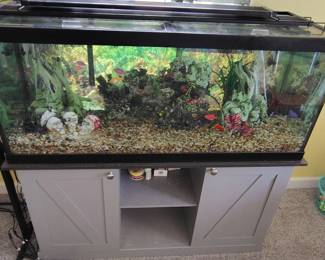 Large tropical fish tank with modern farmhouse base.