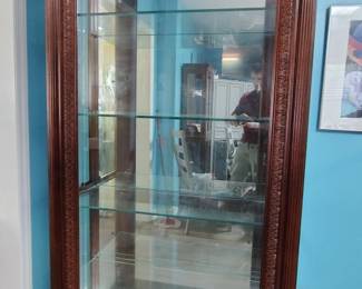 Great large glass curio cabinet with roman column accents.