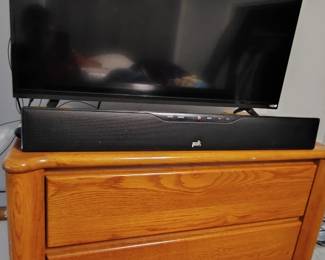 Modernist tall dresser and TV with Polk Audio soundbar 