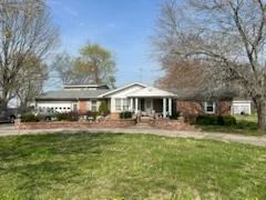 Three Bedroom Two Bath  Home-with dining room, living room w/elec. log fireplace, kitchen w/bar, bath w/jacuzzi/shower & double vanity, sunroom, two car garage, shop, carport, gazebo storage bldgs, new roof & ch/a. plus two story efficiency apartment w/2 baths & kitchen.