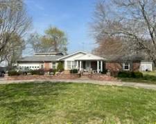 Three Bedroom Two Bath  Home-with dining room, living room w/elec. log fireplace, kitchen w/bar, bath w/jacuzzi/shower & double vanity, sunroom, two car garage, shop, carport, gazebo storage bldgs, new roof & ch/a. plus two story efficiency apartment w/2 baths & kitchen.