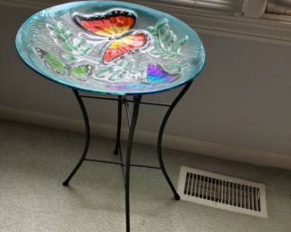 Glass bowl with butterflies on folding iron stand