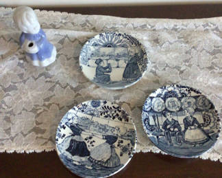 Lot 100: Blue-and-white Delftware plates with a porcelain figurine