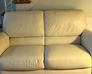 Lot 52:  Cream leather love seat 63”