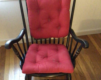 Lot 55: Black wooden rocking chair with red tufted cushions
