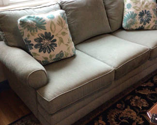 Lot 73: upholstered sofa with floral throw pillows