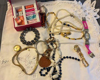 Lot 107: Jewelry assortment with necklaces, bracelets, and watch