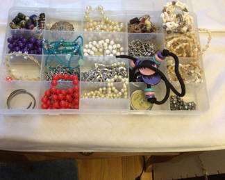 Lot 135: Assorted beads and jewelry in a compartment organizer