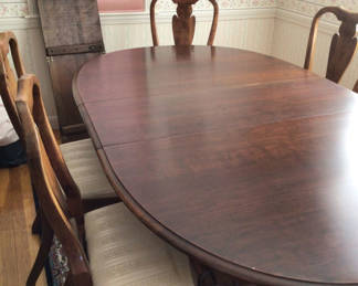 Lot 1: Oval dining table with six carved wooden chairs