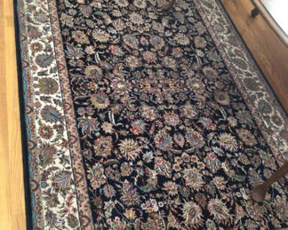 Lot 2: Oriental rug with black floral center and decorative border