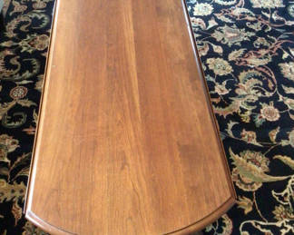 Lot 95: Oval wooden coffee table with drop-leaf ends