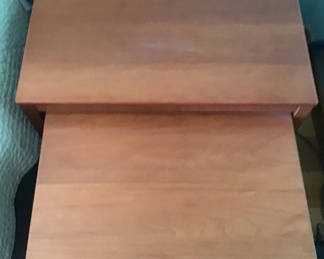 Lot 130: Three wooden nesting tables - surface wear on the larger table