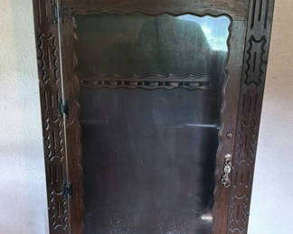 Lot 101: Carved dark wood display cabinet with glass door