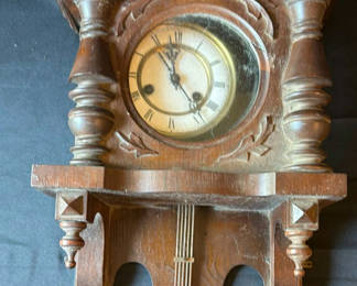 Lot 102: Antique carved wooden pendulum wall clock