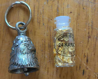 Lot 284: Bell keychain and vial of 24K gold flakes