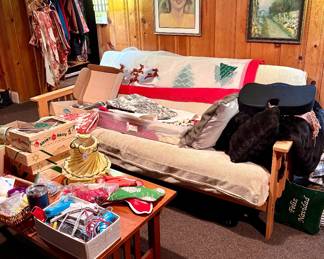 Futon, Cherry Coffee table, shiny brite ornaments, magnificent hand made vintage table cloth on back of futon, faux fur pillows and throws.