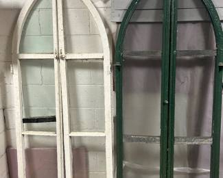 Set of arch windows. White pair has glass. The green pair are screens.