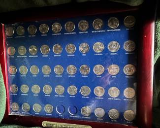 State quarters (missing only two) in a frame.