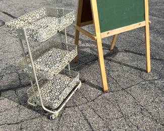 A three-way shelf rolling cart and a child’s two sided chalkboard