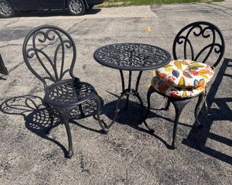 3 piece patio table and chair  set with two cushions.