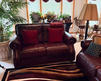 Dark Brown Leather Loveseat with Decorative Pillows and Nailhead Trim