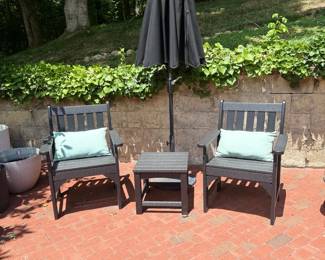Outdoor Patio Dining Set Dark Wood Chairs Blue Pillows Umbrella Brick Patio