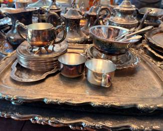 Silverplate creamers, sugars and cups on tray