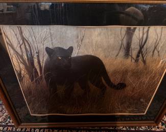 Framed art of a black panther in a winter landscape