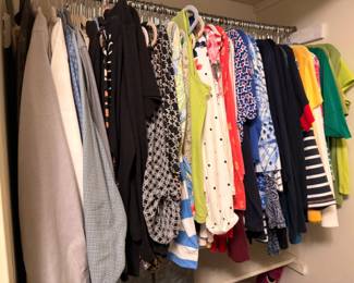 Women's clothing, dresses, tops and jackets on hangers